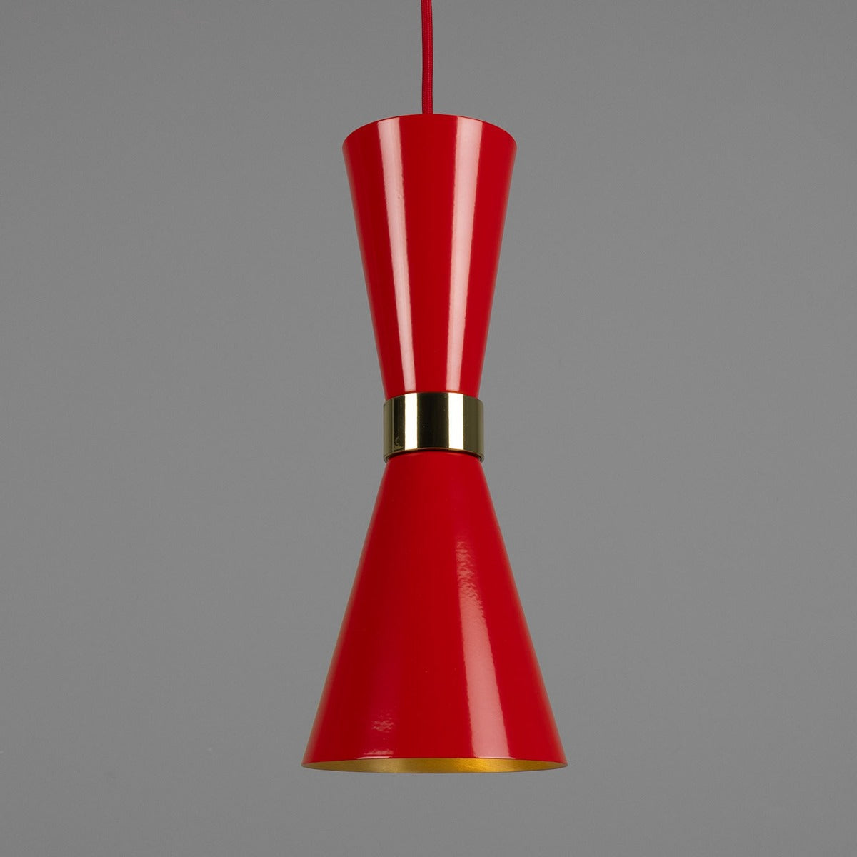 Red pendant light with gold accent on a gray background