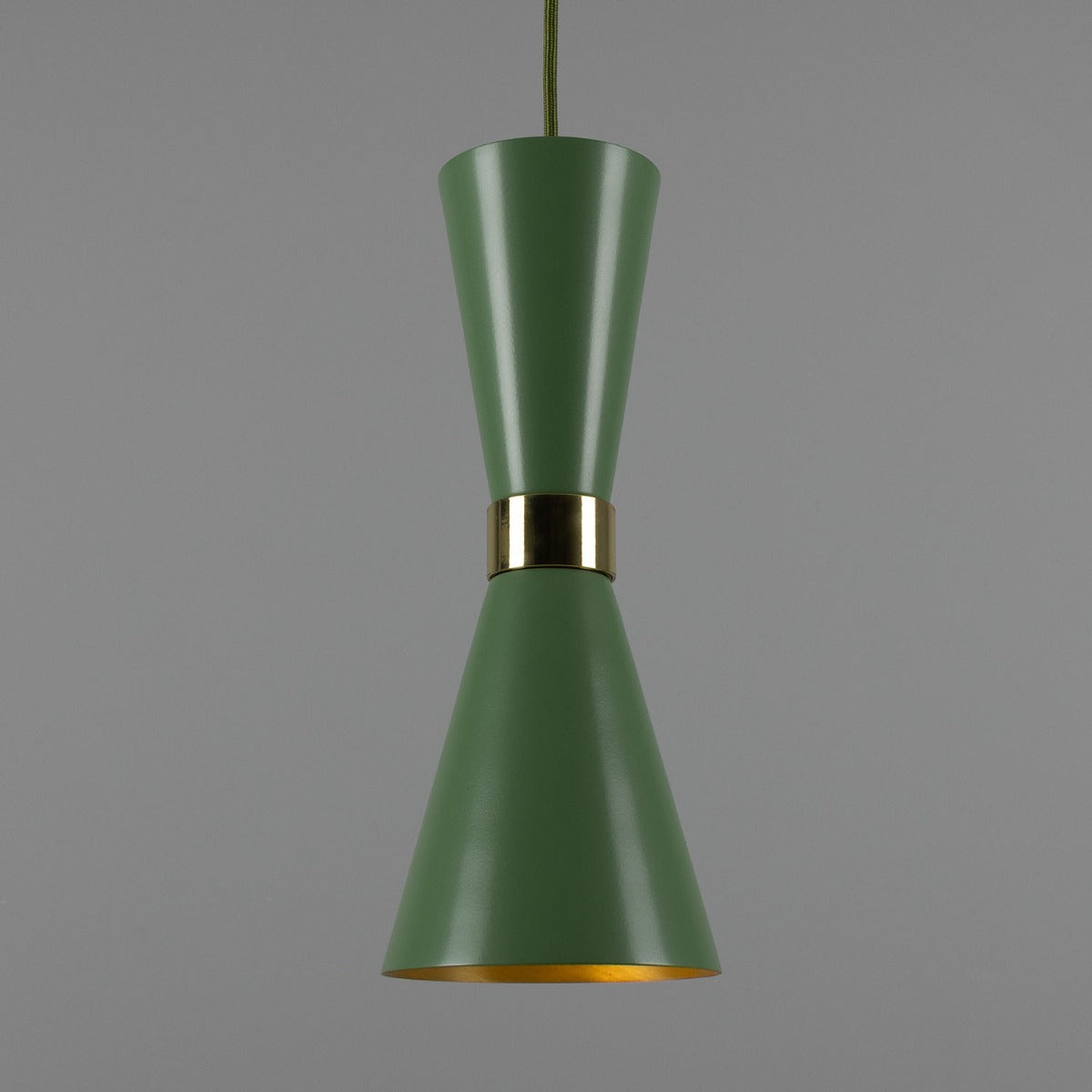 Green pendant light with gold accent on a gray background