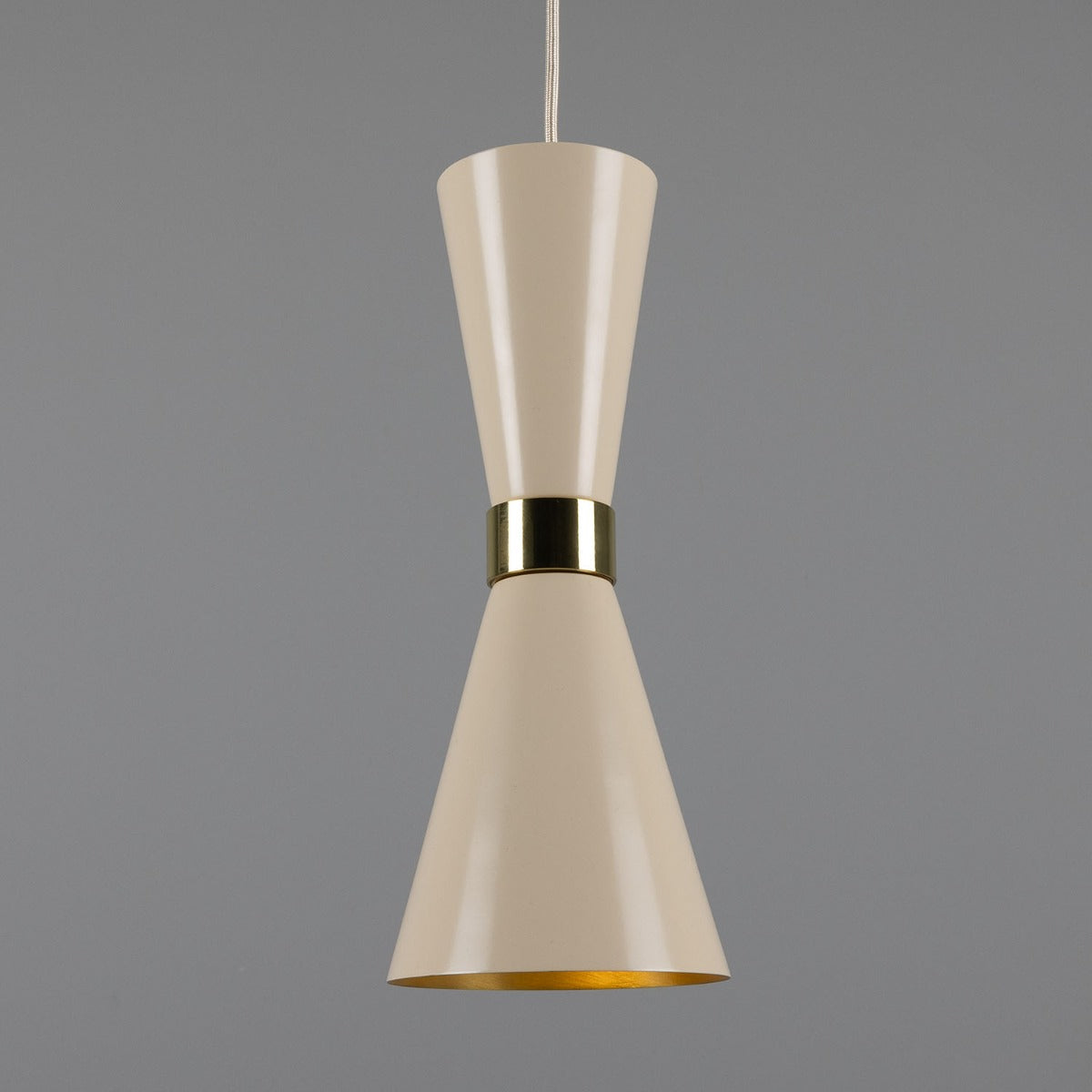 Beige pendant light with gold accent on a gray background