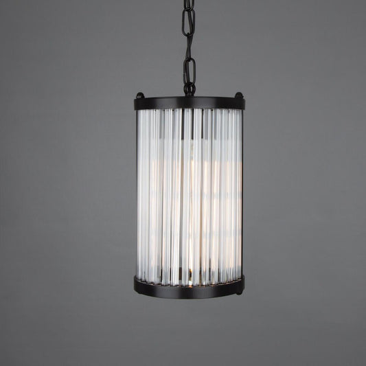 Pendant light with black frame and ribbed glass shade on a gray background