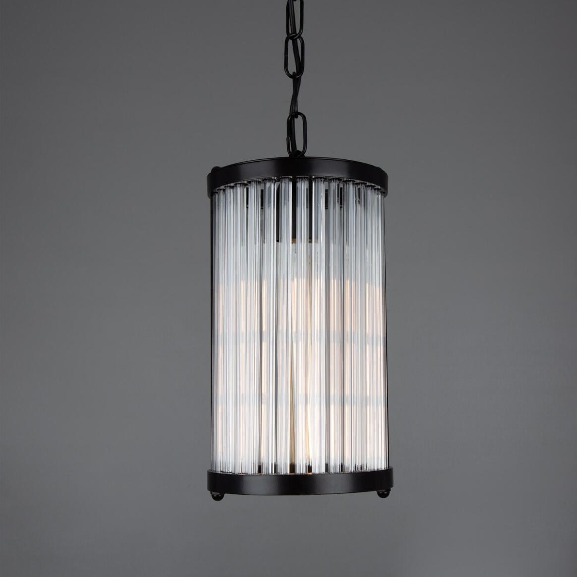 Pendant light with black frame and ribbed glass shade on a gray background