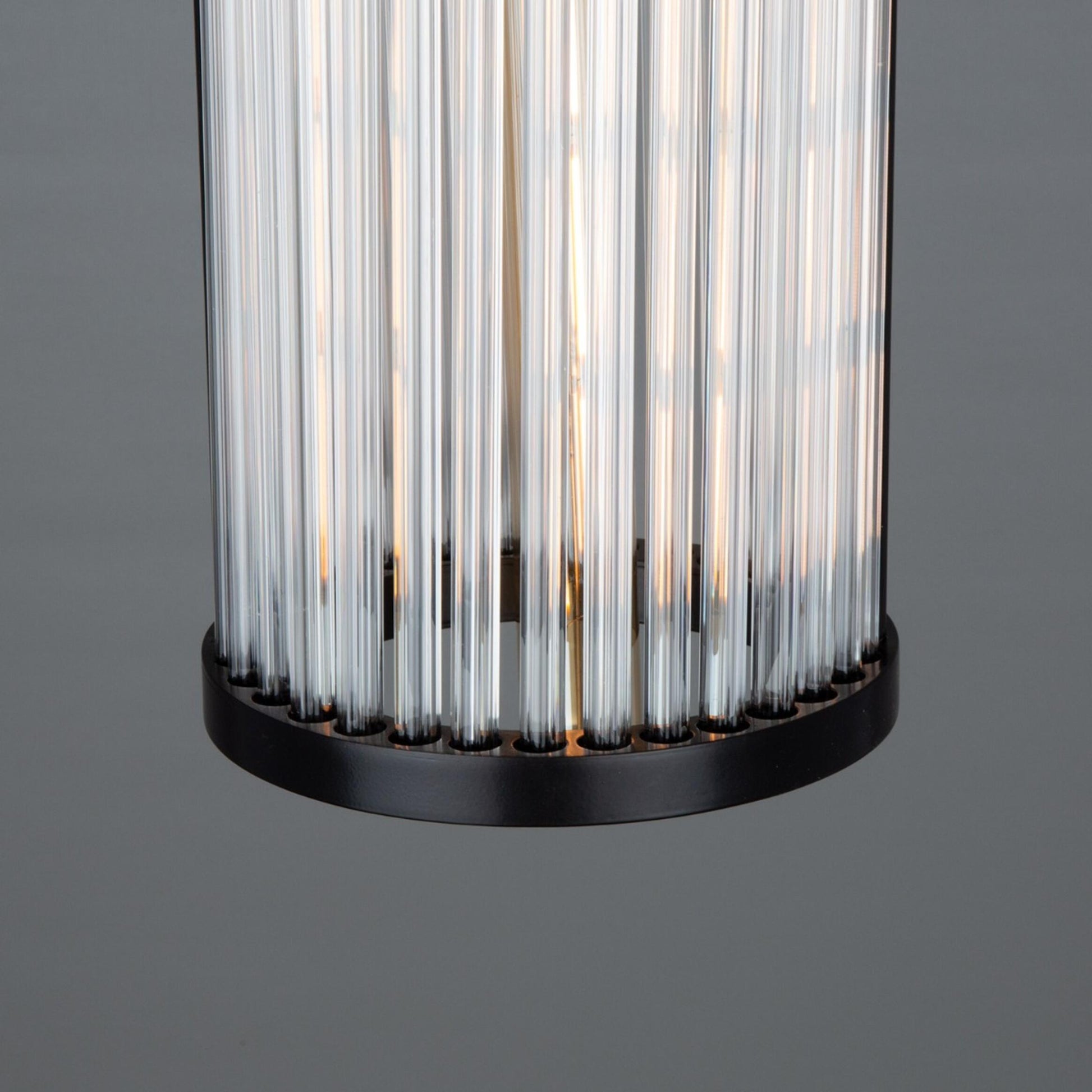 Cylindrical light fixture with ribbed design on a gray background