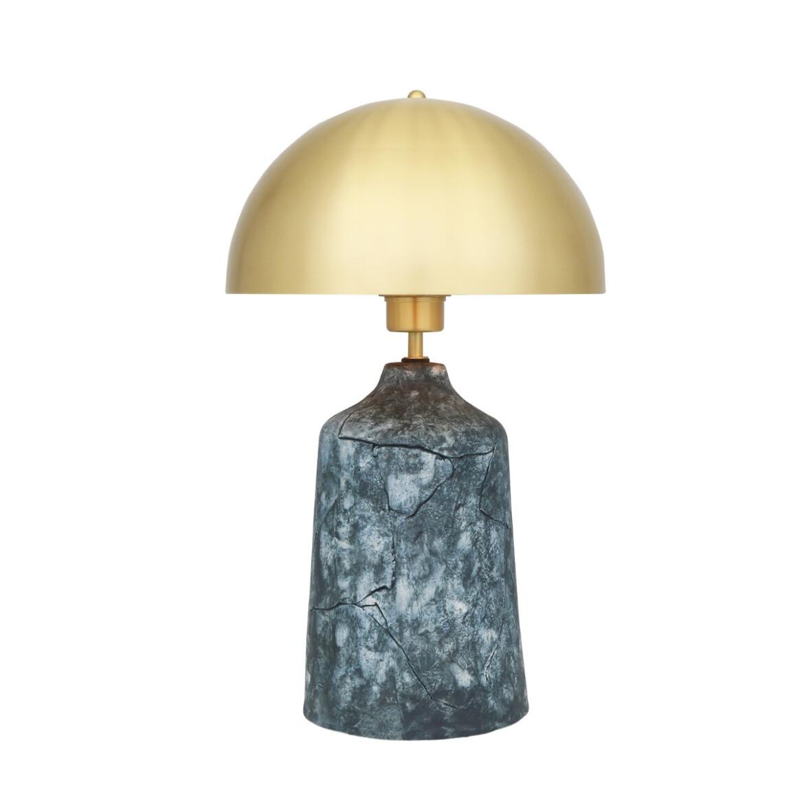 Table lamp with gold shade and marble base on a white background