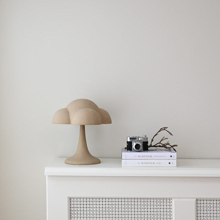 Fungus Table Lamp by 101 Copenhagen with a mushroom-inspired shape and smooth ceramic finish on a minimalist surface