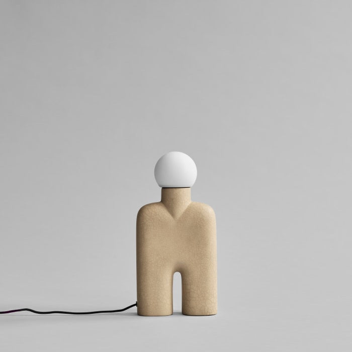 Cobra Table Lamp by 101 Copenhagen featuring a curved, snake-like silhouette in a matte ceramic finish on a minimalist table