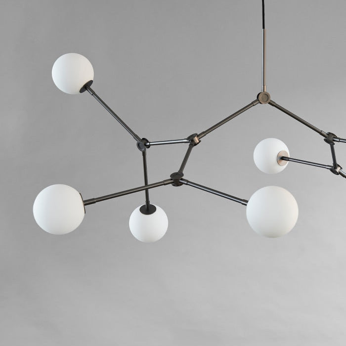 Drop Chandelier Bulb by 101 Copenhagen featuring multiple adjustable arms and exposed bulbs in a minimalist, sculptural design for modern living spaces.






