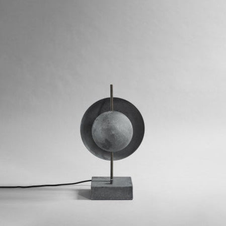 Dusk Table Lamp by 101 Copenhagen featuring a sculptural ceramic base with soft ambient lighting on a modern console table.