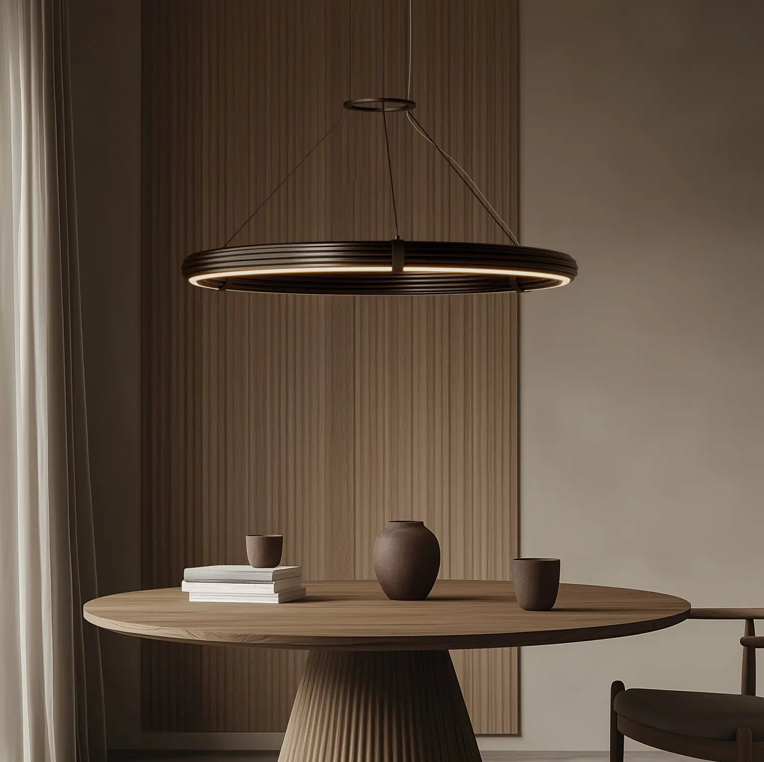 Elli Large pendant light hanging above a wooden table with decor items in a minimalistic room.
