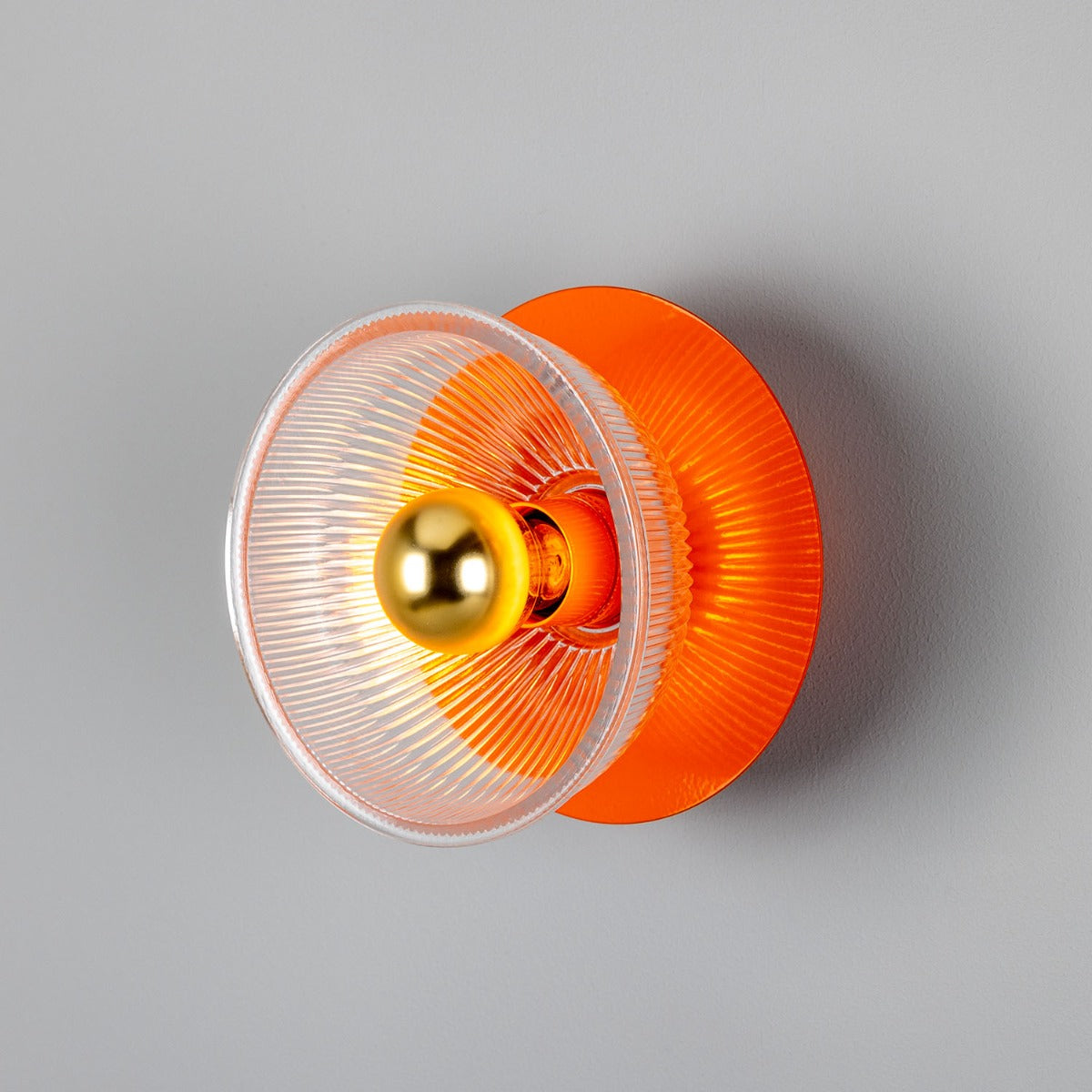 Eclipse Coloured Brass and Prismatic Glass Dish Wall Light by Mullan Lighting with a radiant brass finish and textured prismatic glass for elegant ambient lighting