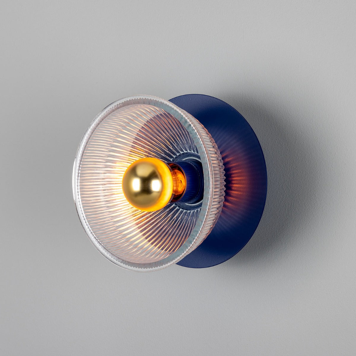 Modern wall light fixture with blue and silver design on a gray background