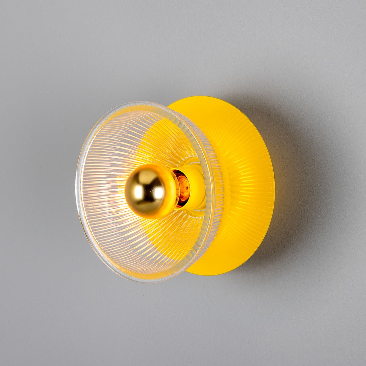 Yellow and clear yoyo on a gray background