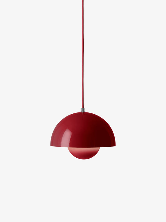 Side view of the Flowerpot VP1 pendant casting a soft glow in a contemporary setting.

