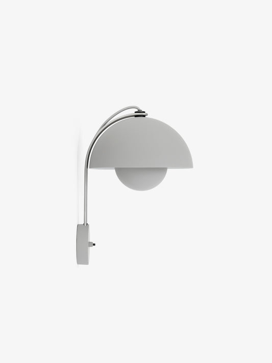 The Flowerpot VP8 wall lamp by &Tradition illuminating a hallway with soft, focused light.

