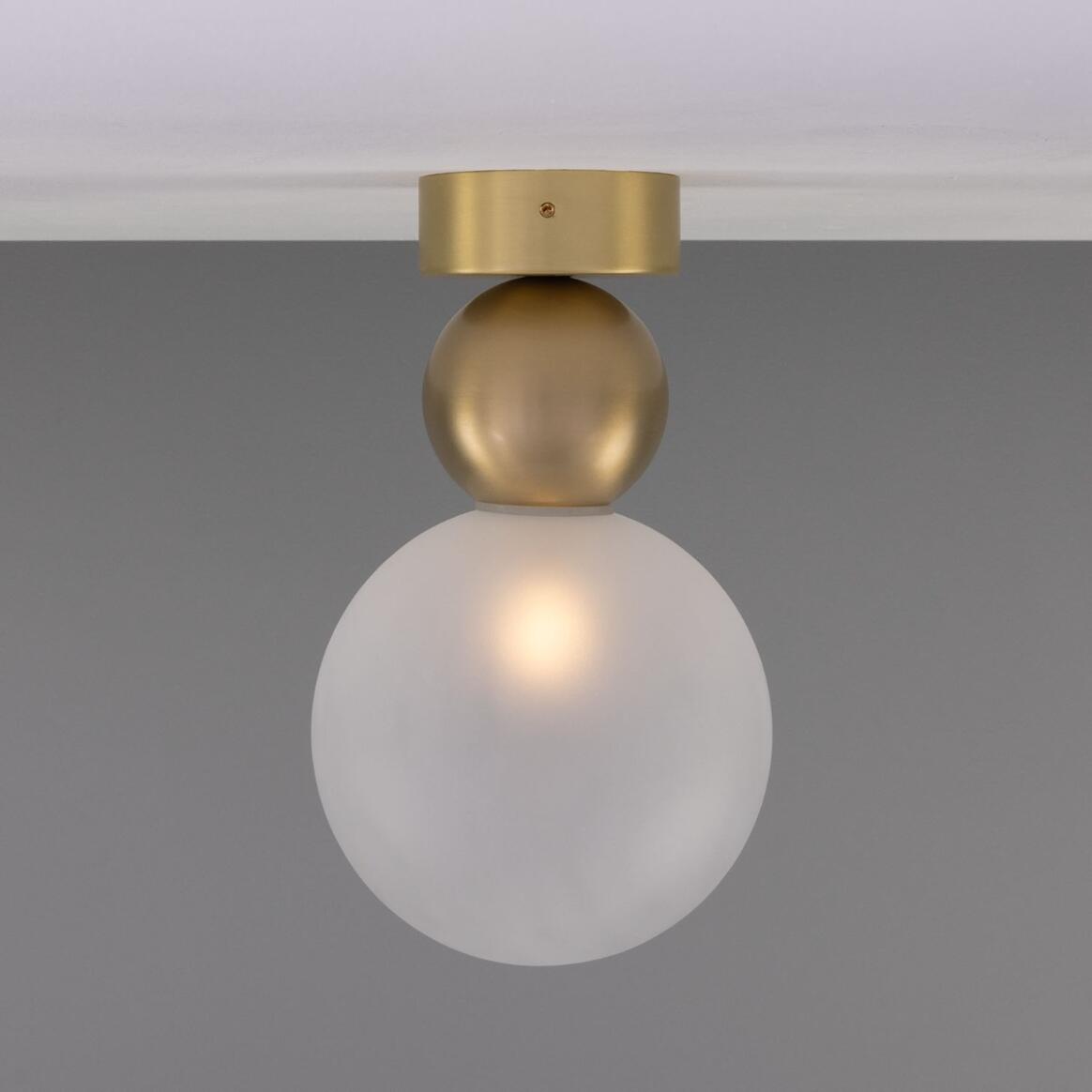 Helena Ceiling Lamp by Mullan Lighting with a minimalist brass sphere and 15cm glass globe shade, available in clear or frosted glass for modern interiors