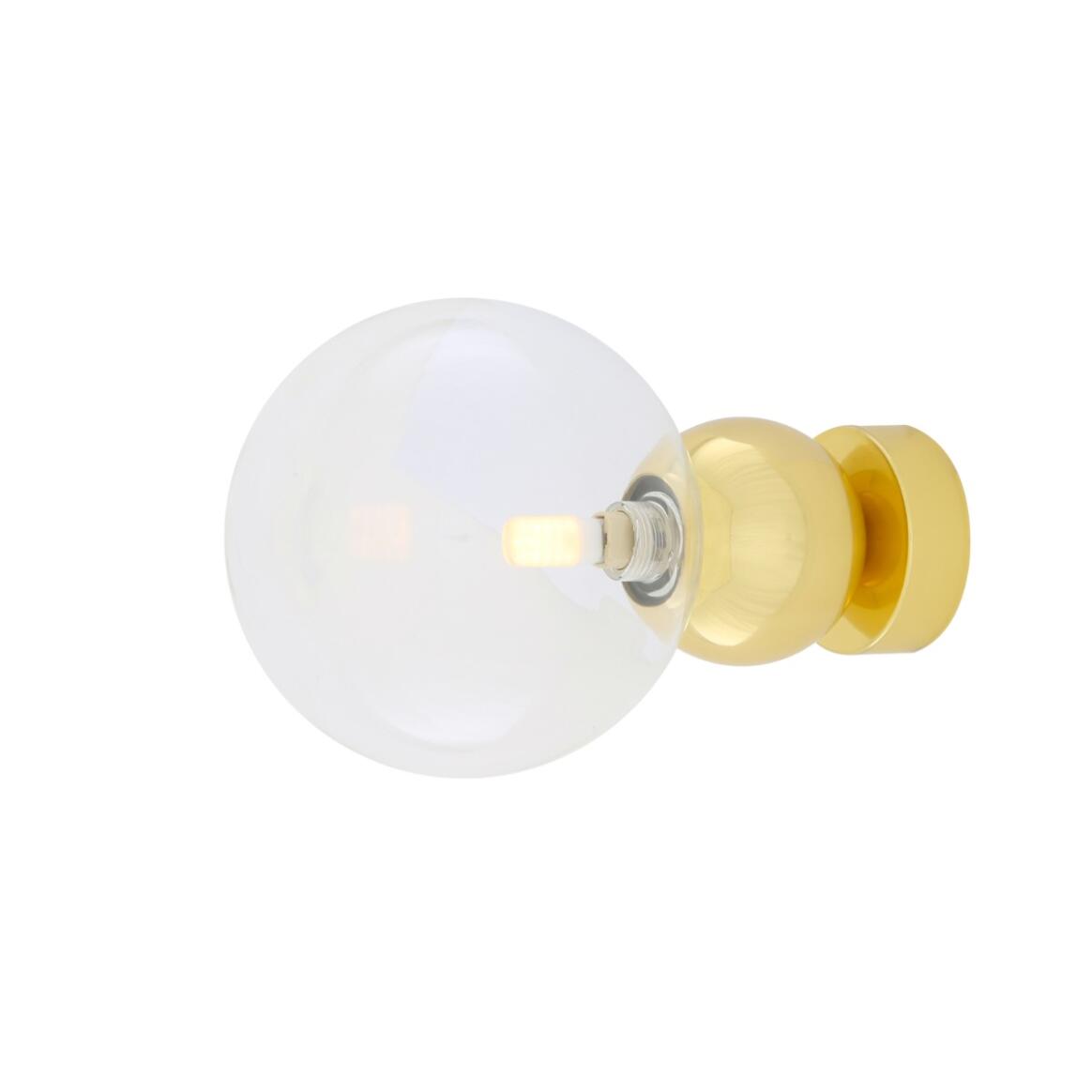 Wall-mounted light fixture with a white globe shade and gold base on a white background