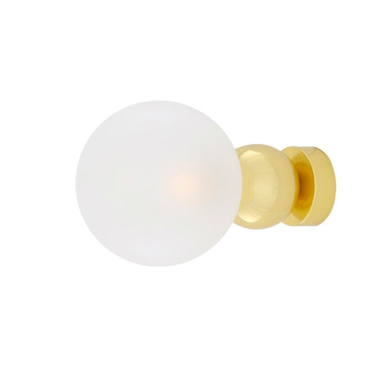 White spherical knob with gold base on a white background