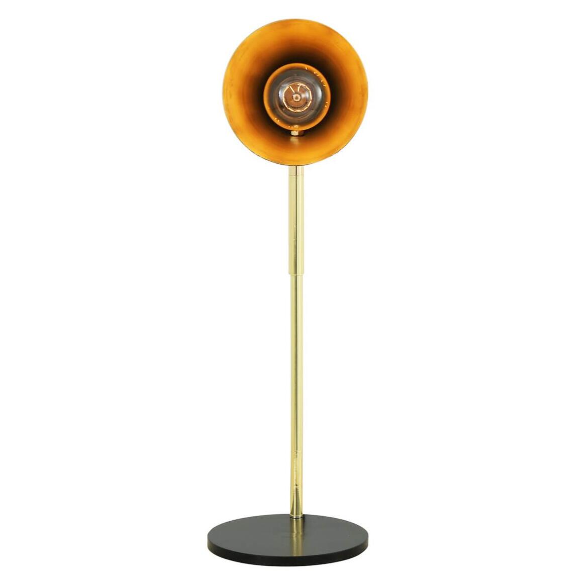 Modern floor lamp with orange shade and gold pole on a white background