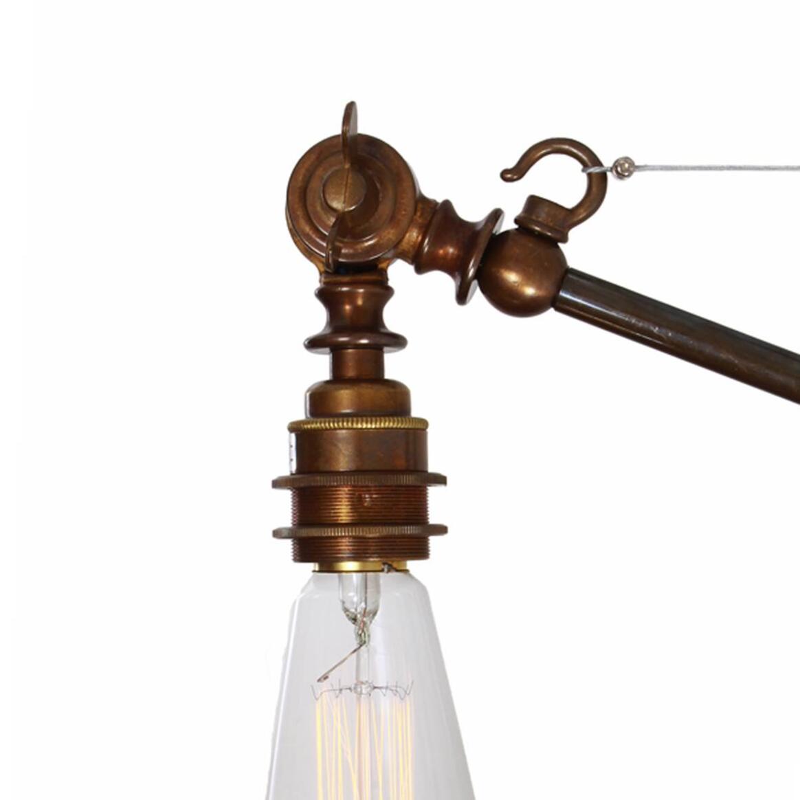 Vintage-style lamp with brass fixture and clear bulb on a white background