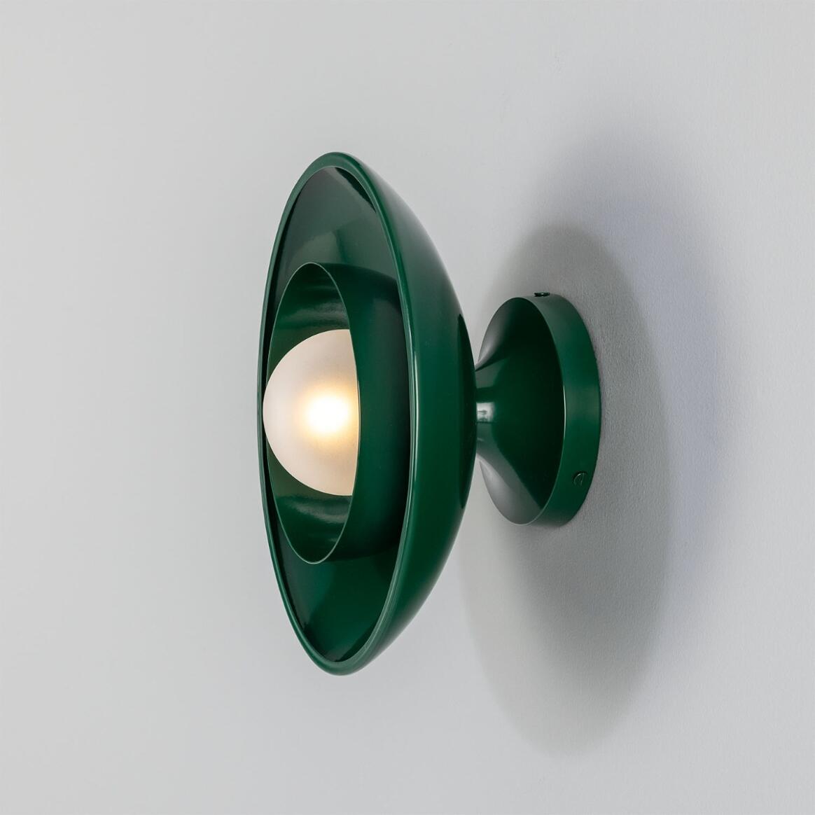 Green wall-mounted lamp on a white background