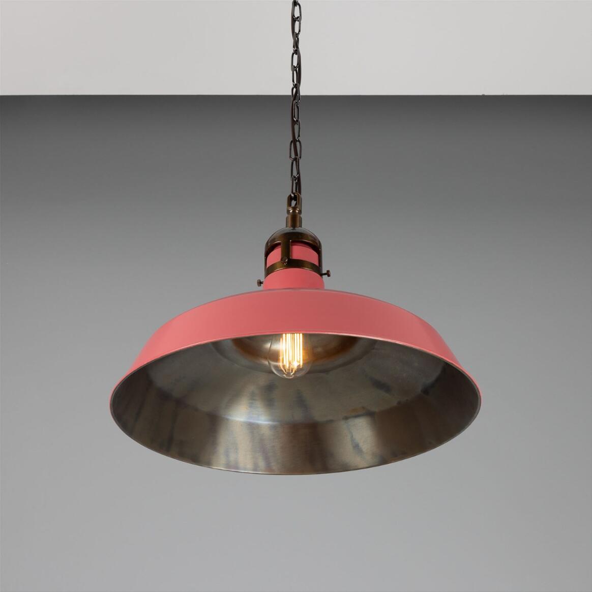 Pink pendant light with metallic shade on a gray background