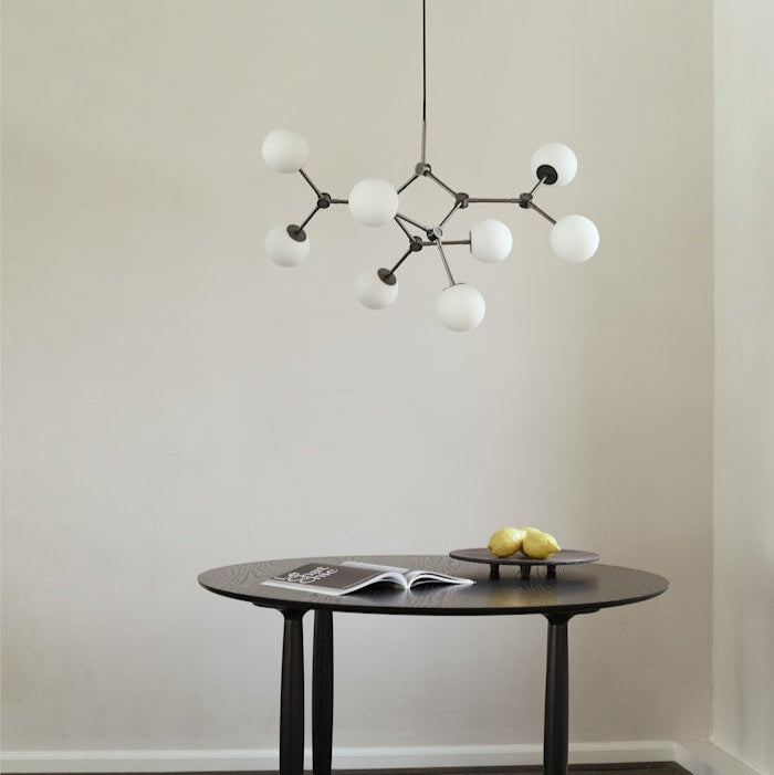 Drop Chandelier Bulb by 101 Copenhagen featuring multiple adjustable arms and exposed bulbs in a minimalist, sculptural design for modern living spaces.






