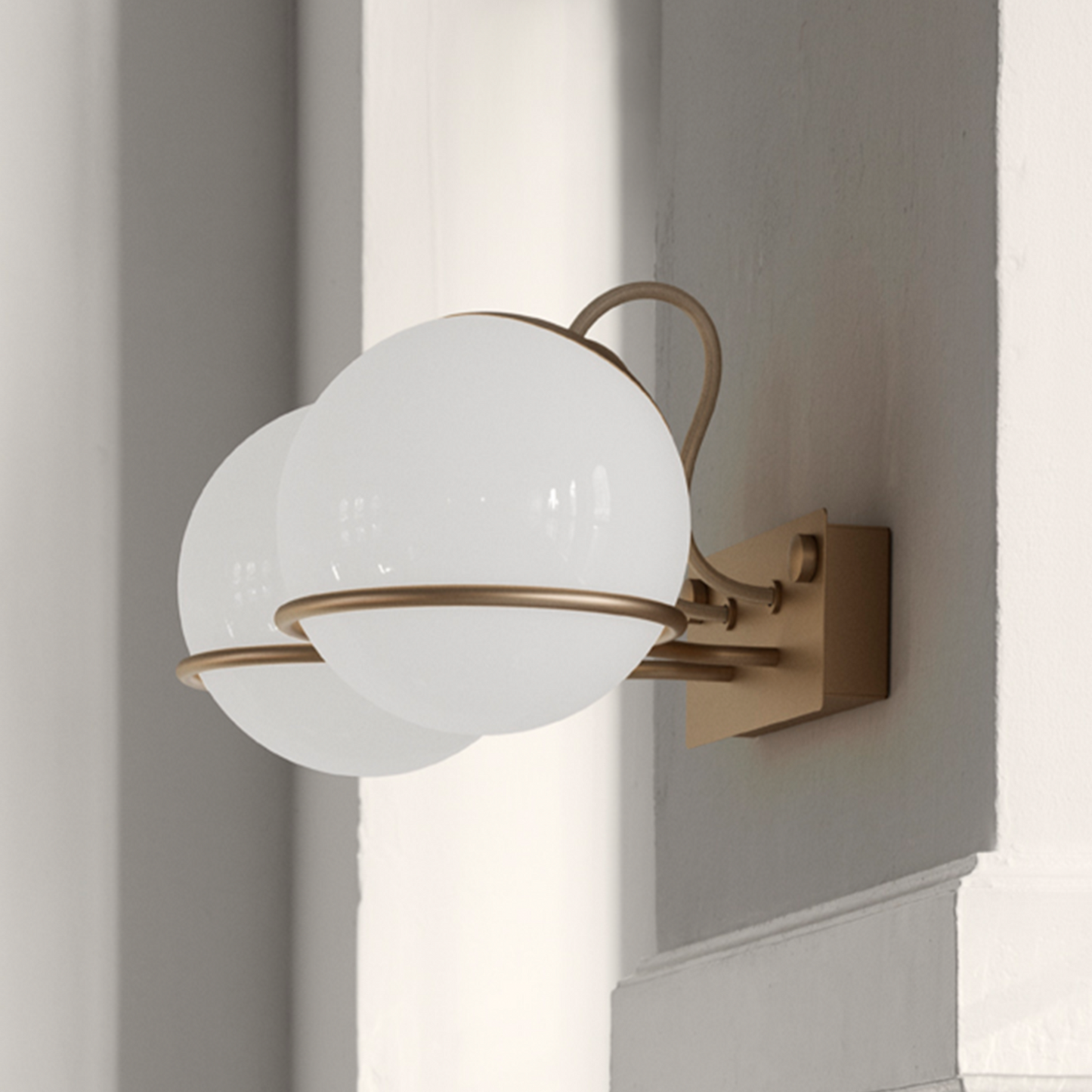 Astep Model 238/2 wall lamp with two 20 cm opaline glass globes held by black (or champagne) steel rings, mounted on rectangular backplate
