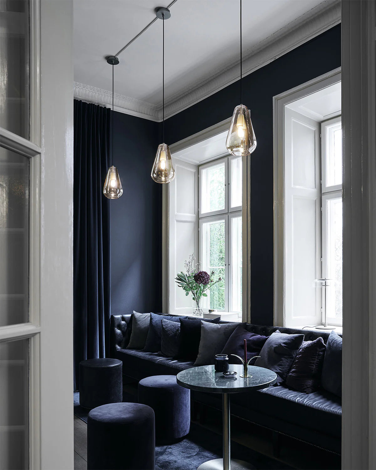 Anoli 1 medium pendant lamp by Nuura with a snowdrop-inspired opal glass shade, gold metal details, and black cord — perfect for Nordic minimalist lighting.