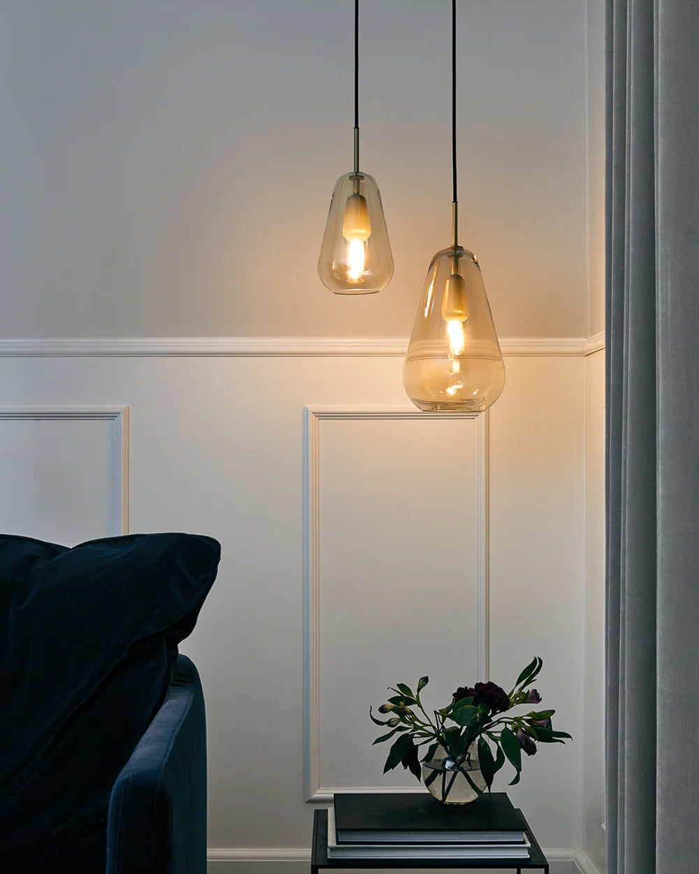 Anoli 1 medium pendant lamp by Nuura with a snowdrop-inspired opal glass shade, gold metal details, and black cord — perfect for Nordic minimalist lighting.