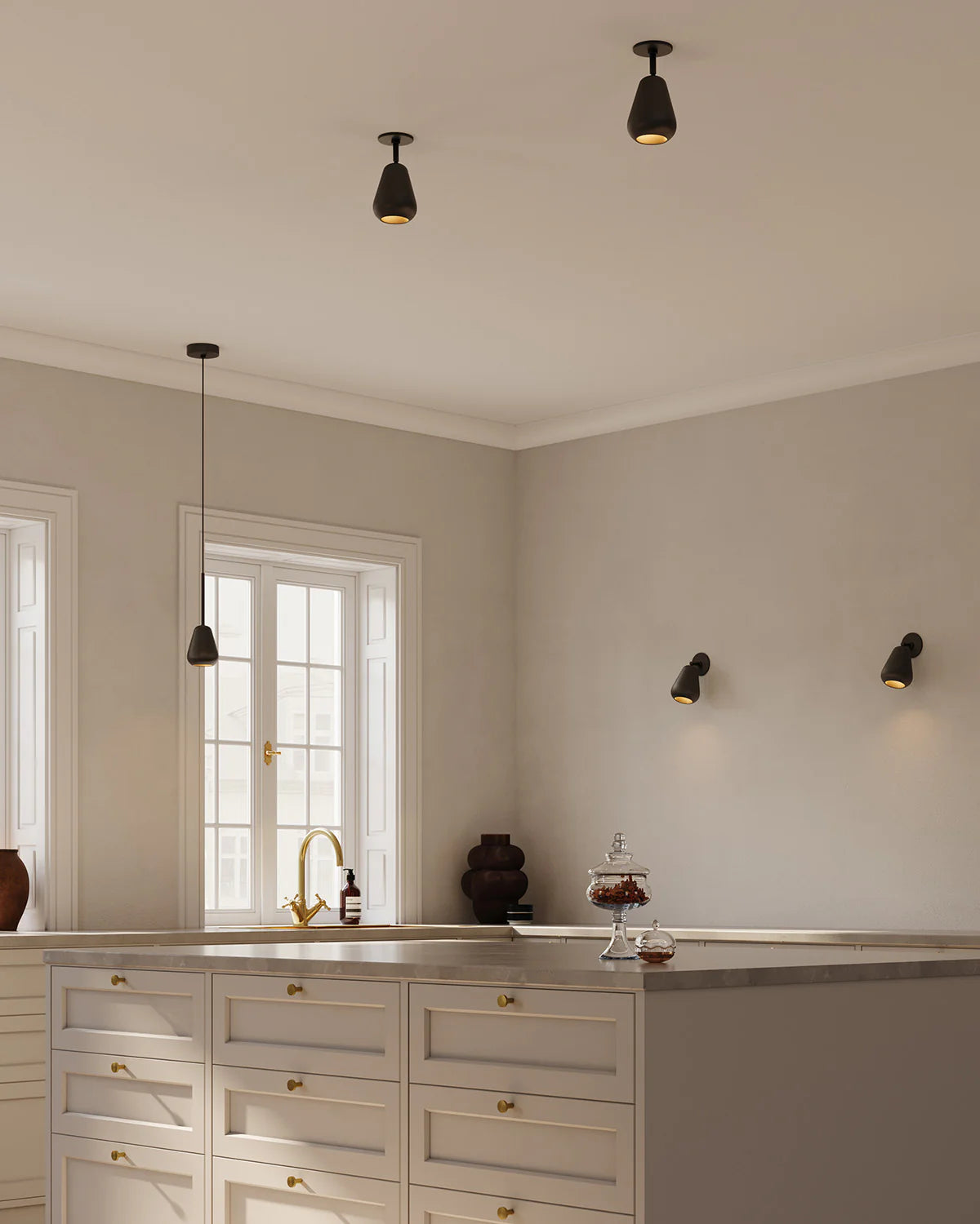 Anoli Spot Pendant by Nuura featuring a white metal teardrop shade, gold suspension, and black fabric cord for modern, focused interior lighting.