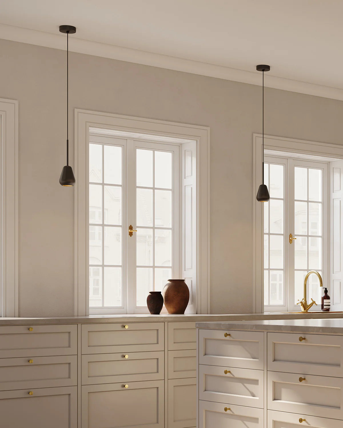 Anoli Spot Pendant by Nuura featuring a white metal teardrop shade, gold suspension, and black fabric cord for modern, focused interior lighting.