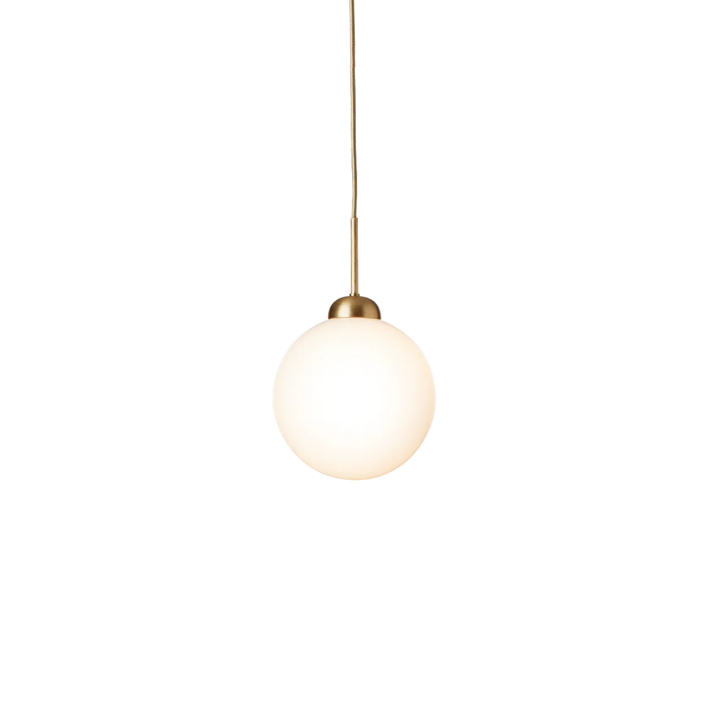 Close-up of Nuura Apiales 1 pendant lamp featuring a hand-blown opal glass shade and elegant brushed brass finish.