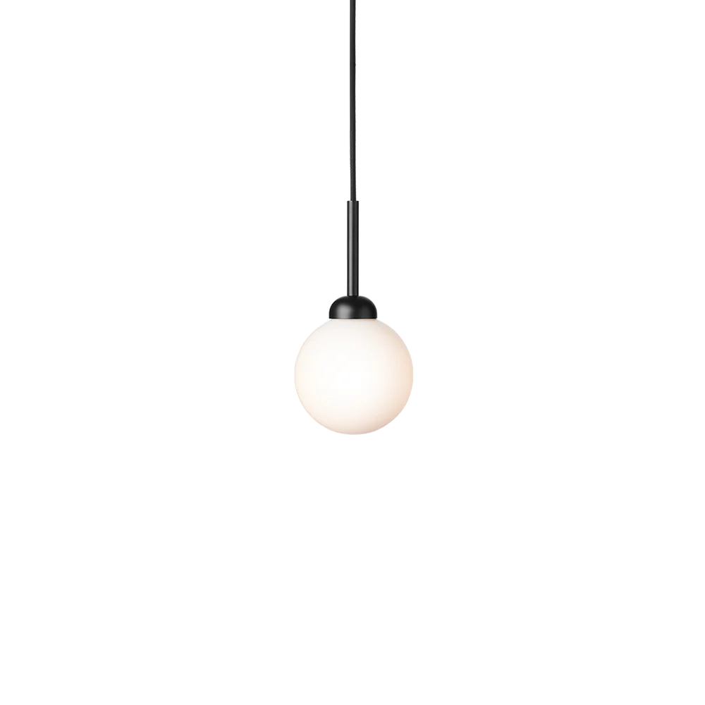 Close-up of Nuura Apiales 1 pendant lamp featuring a hand-blown opal glass shade and elegant brushed brass finish.