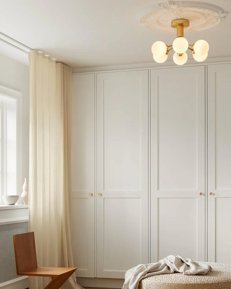 Modern ceiling chandelier from Nuura with patterned glass domes and matte black finish, suitable for stylish low-ceilinged rooms.

