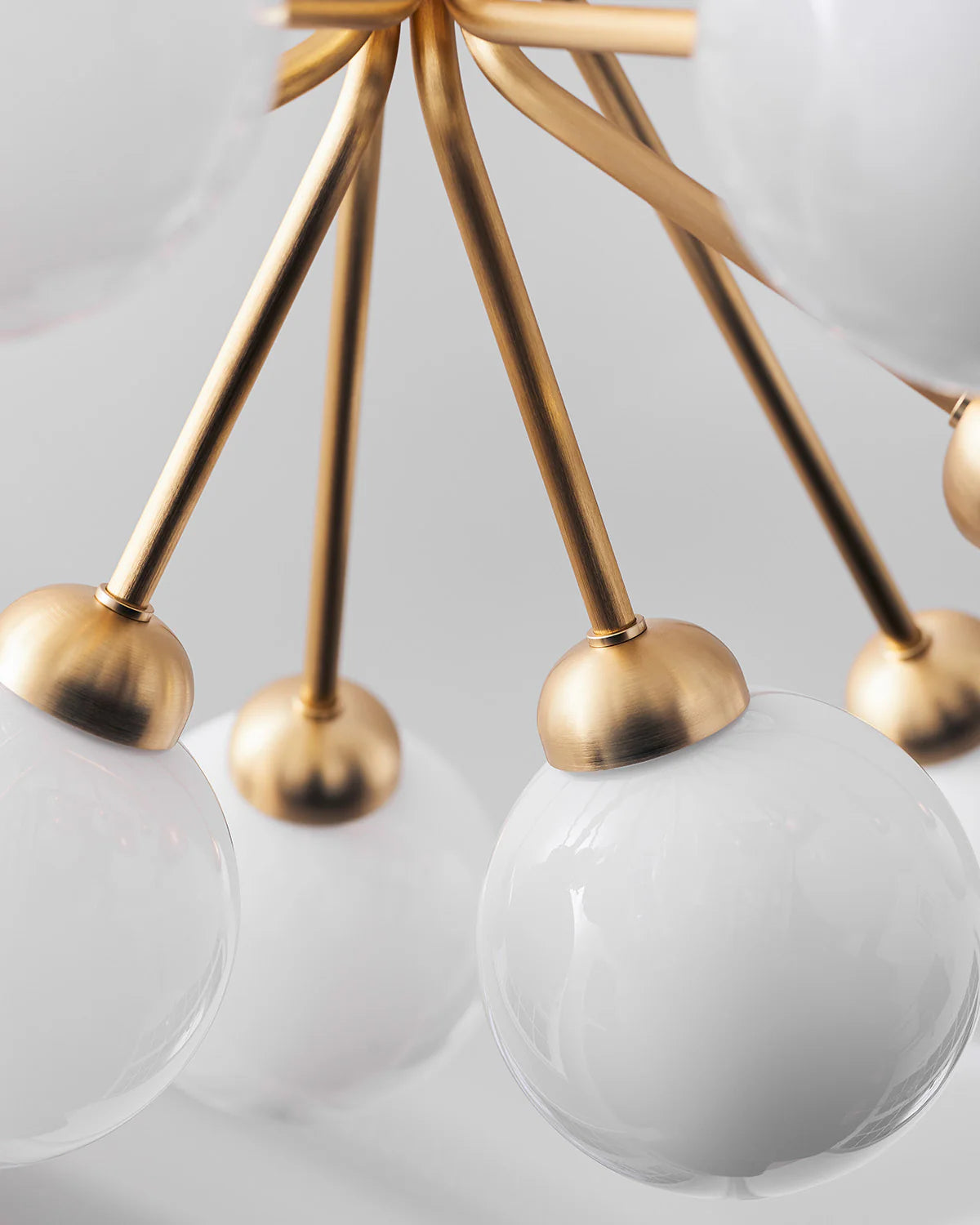 Nuura Apiales 9 chandelier with satin black arms and nine smoked glass shades, designed for modern interiors with elegant, ambient lighting.







