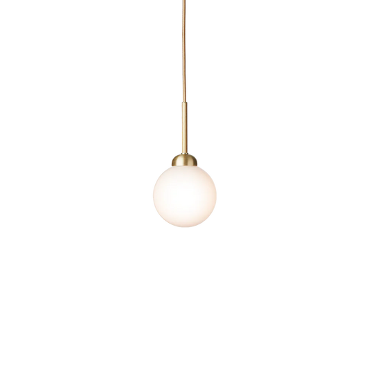 Apiales 1 pendant lamp by Nuura with opal white glass shade and brushed brass details, suspended by a gold fabric-covered cord.







