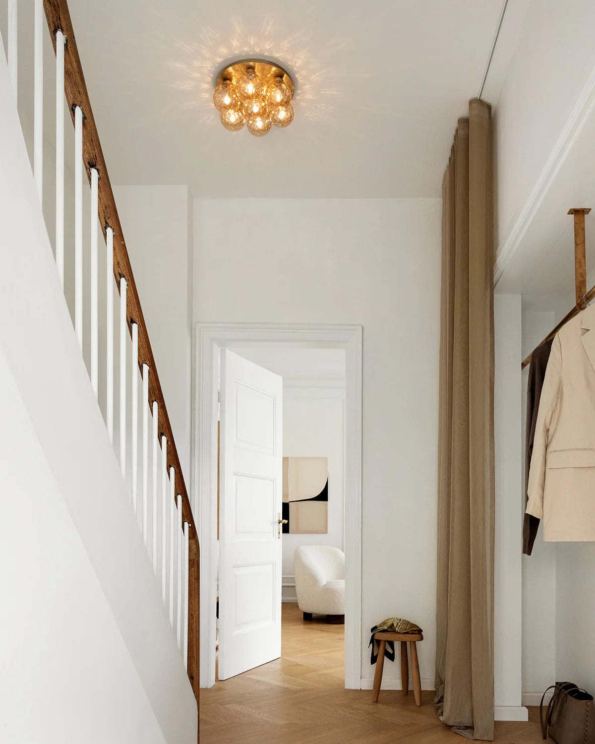 Apiales 7 Ceiling Lamp by Nuura – golden glass domes on round metal base.

