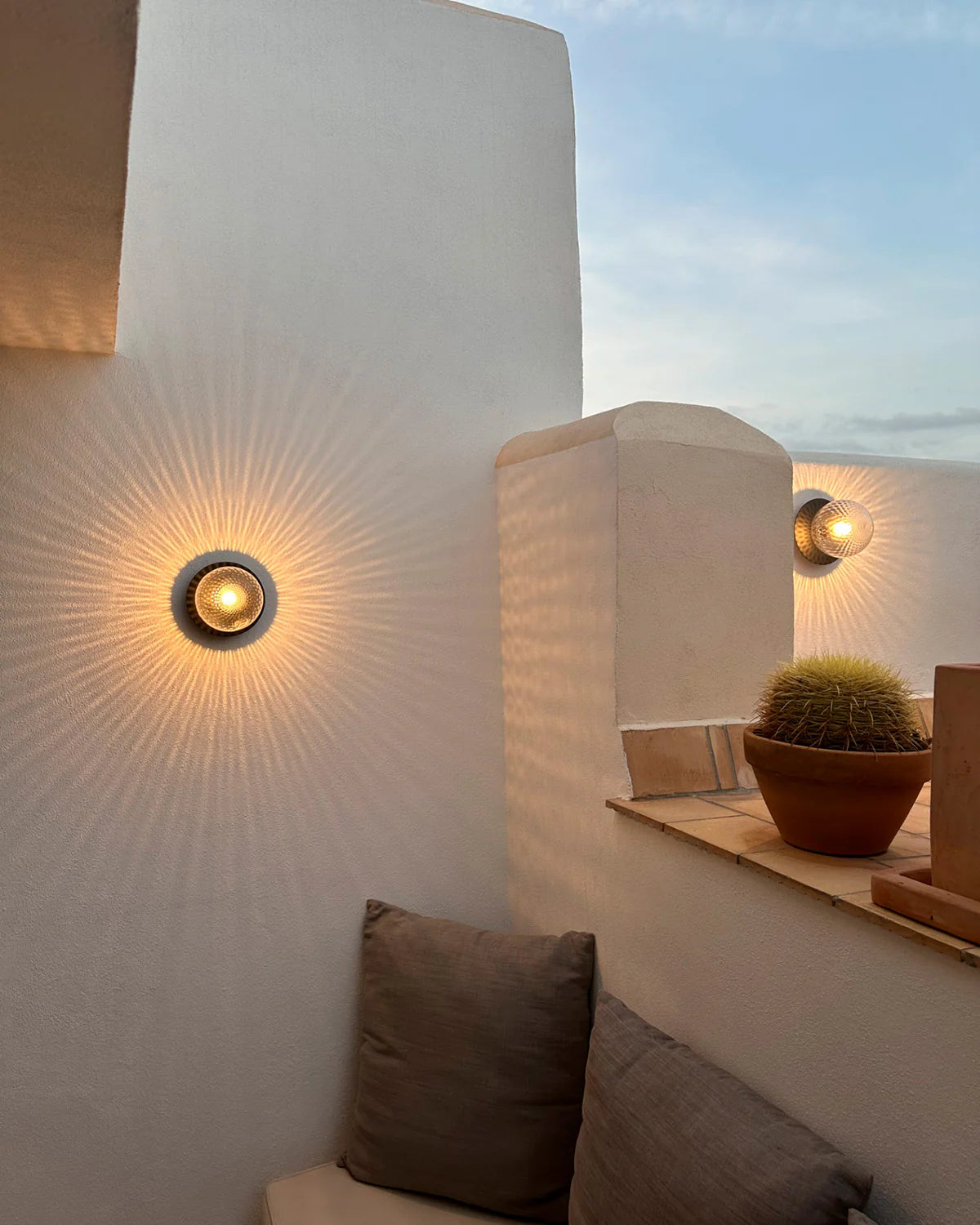 Nuura Liila 1 Outdoor Wall Lamp with bronze finish and clear glass globe, ideal for stylish outdoor wall or ceiling lighting in modern exterior spaces.