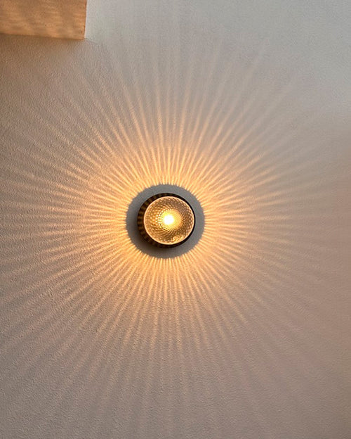 Nuura Liila 1 Outdoor Wall Lamp with bronze finish and clear glass globe, ideal for stylish outdoor wall or ceiling lighting in modern exterior spaces.