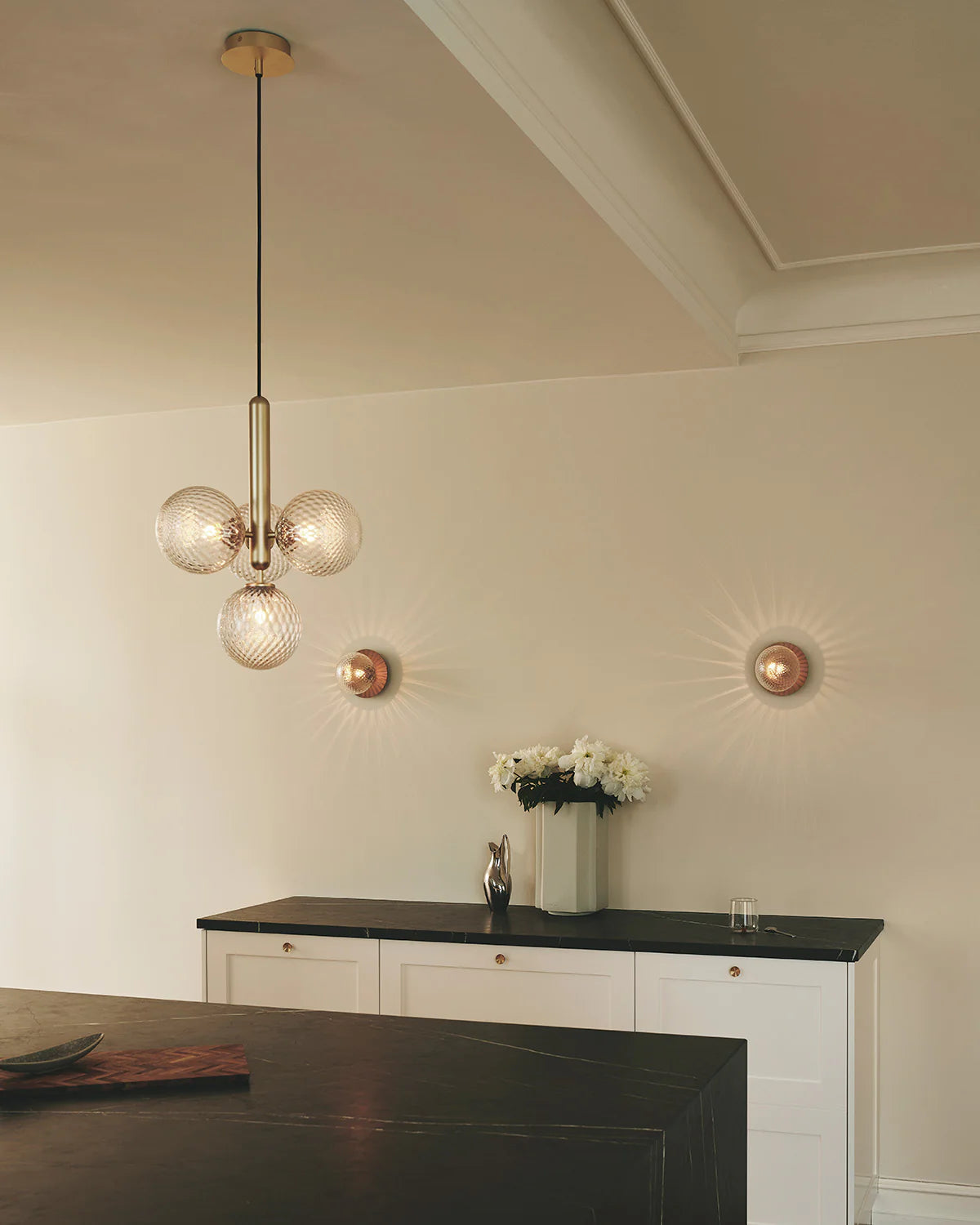Four-light Scandinavian pendant lamp by Nuura, featuring brass frame and clear glass shades for living room , dining room or kitchen lights