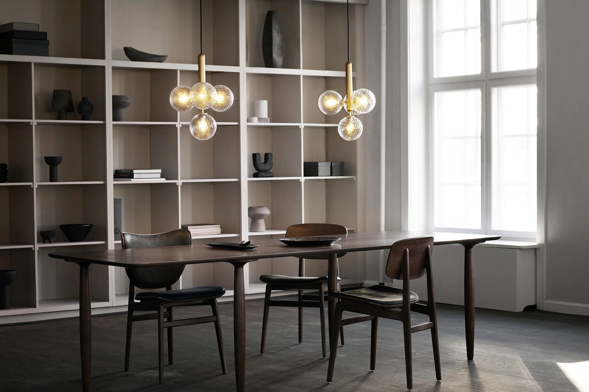 Four-light Scandinavian pendant lamp by Nuura, featuring brass frame and clear glass shades for living room , dining room or kitchen lights