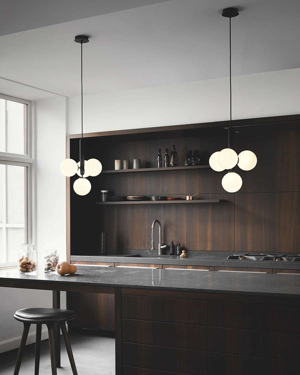 Four-light Scandinavian pendant lamp by Nuura, featuring black frame and opal glass shades for living room , dining room or kitchen lights