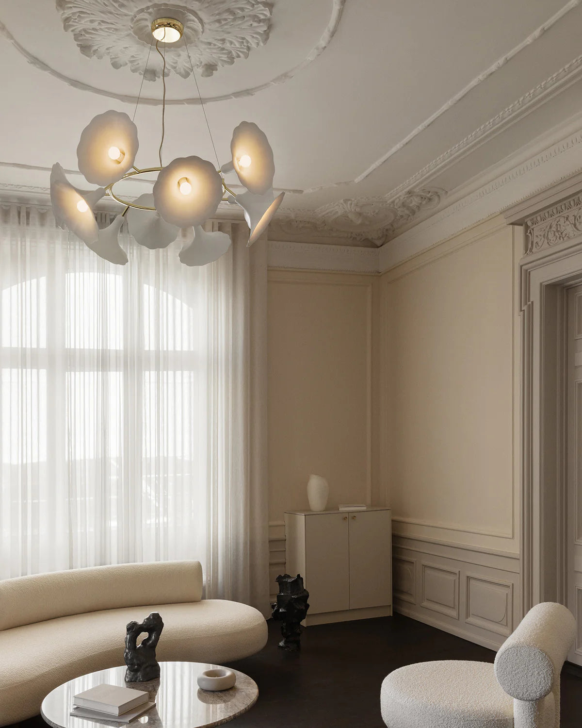 Petalii 10 chandelier with ten white flower-shaped shades and brass ring