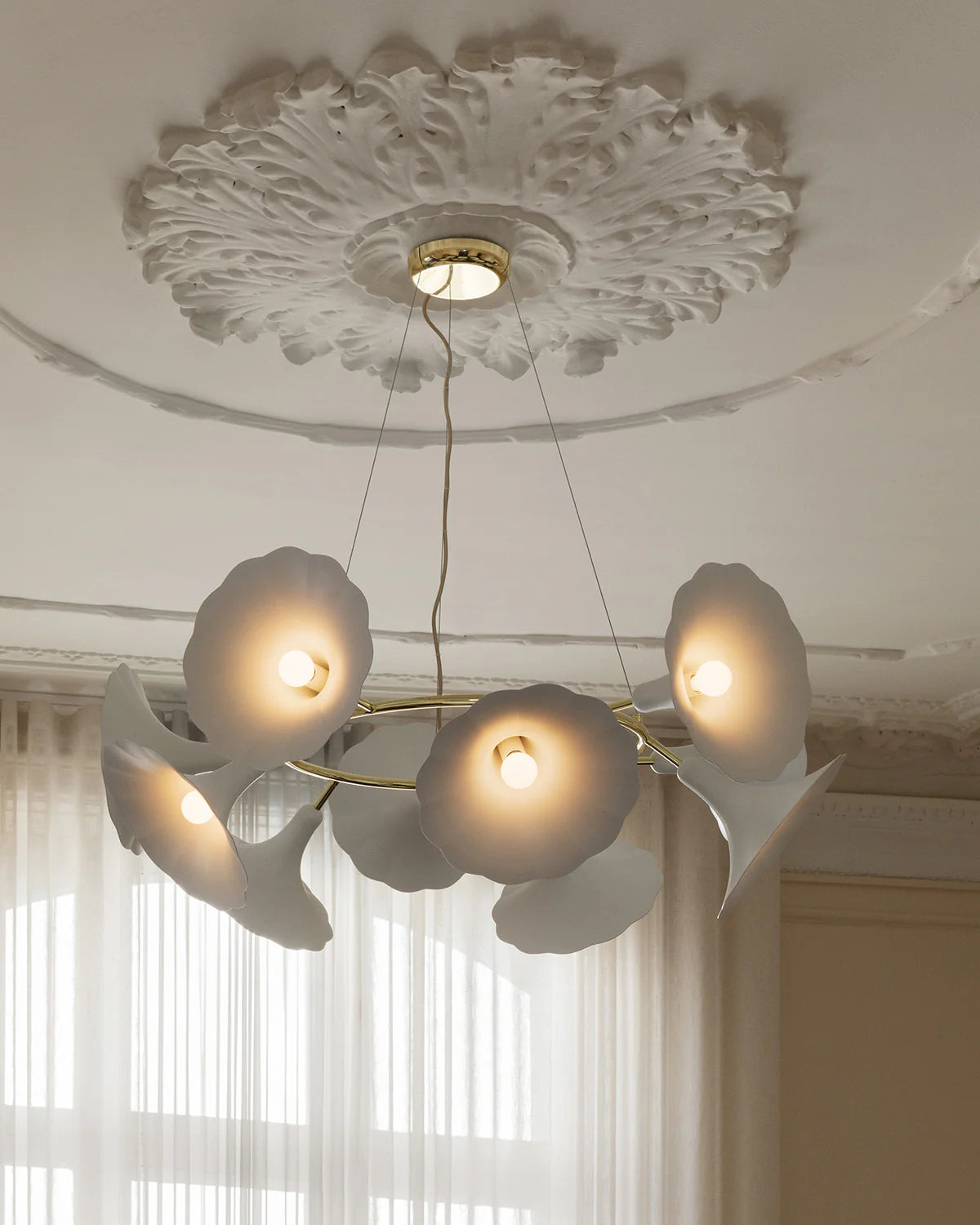 Petalii 10 chandelier with ten white flower-shaped shades and brass ring