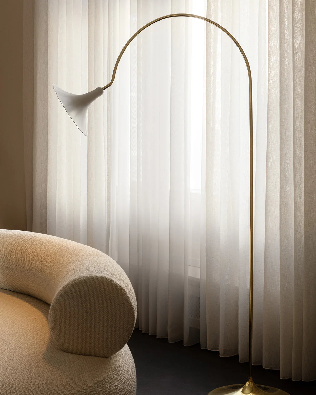 Petalii floor lamp with brass curved stem and white flower-shaped shade