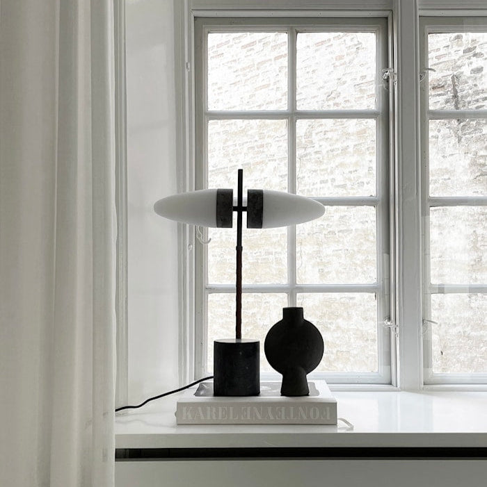 Bull Table Lamp styled in a contemporary living room setup, adding artistic flair and warm ambient light.