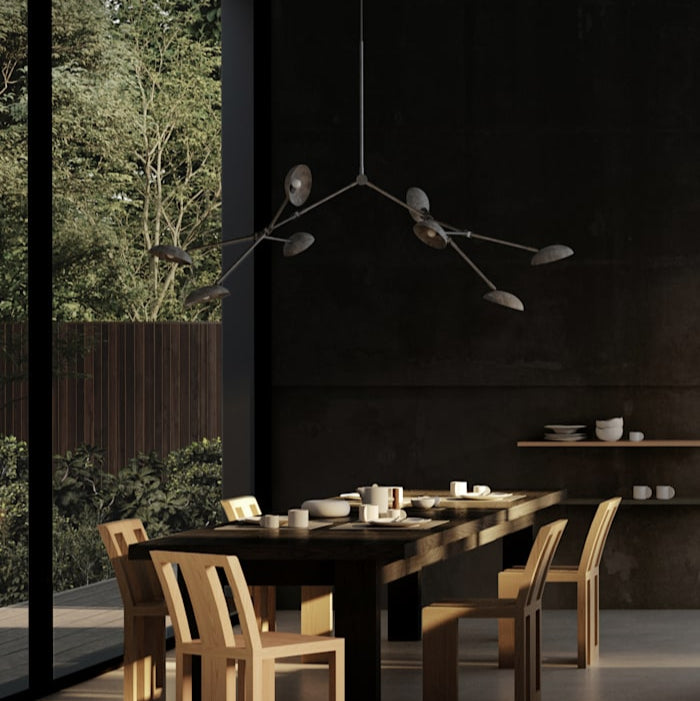 Drop Chandelier by 101 Copenhagen suspended from the ceiling with multiple adjustable arms and opal glass globes