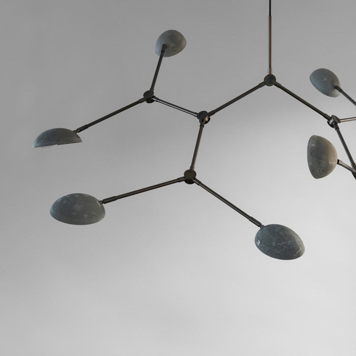  Drop Chandelier by 101 Copenhagen suspended from the ceiling with multiple adjustable arms and opal glass globes