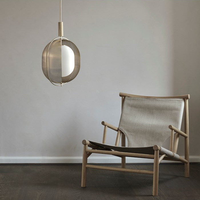 Pearl Pendant Lamp by 101 Copenhagen hanging from the ceiling with multiple opal glass globes and a brass structure.