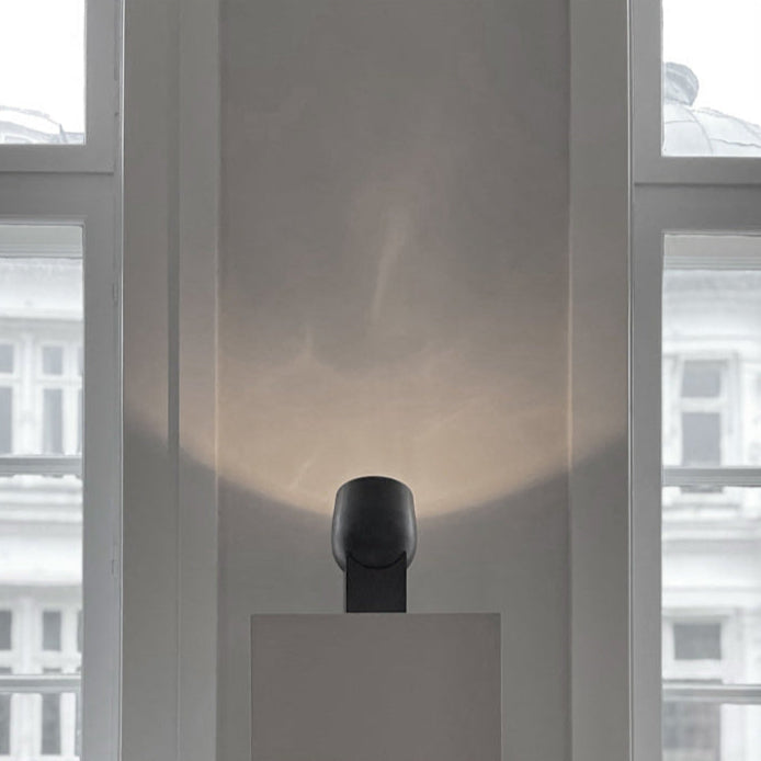 Pivot Table Lamp by 101 Copenhagen with its geometric, rotating design placed on a modern console table.