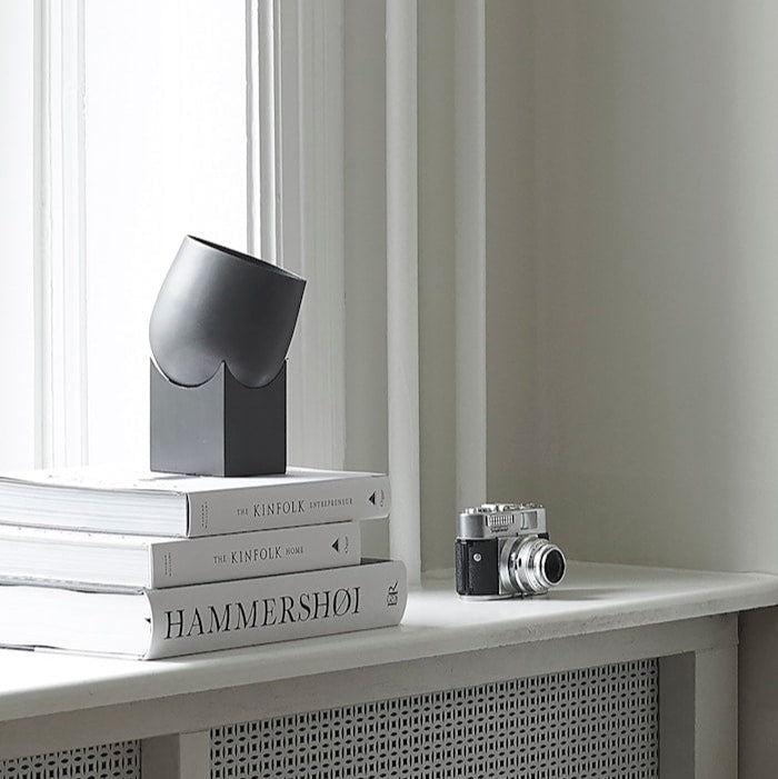 Pivot Table Lamp by 101 Copenhagen with its geometric, rotating design placed on a modern console table.